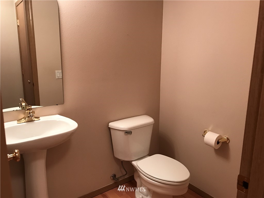 2226 Southeast 2nd Place Renton, WA 98056 - Photo 9 of 20 a bathroom with a toilet a sink and mirror