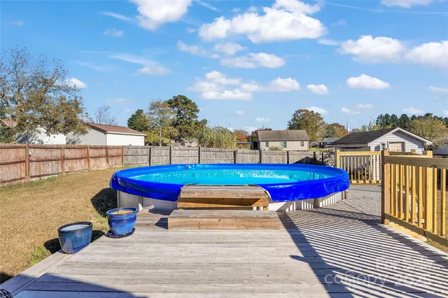 a swimming pool with red chairs