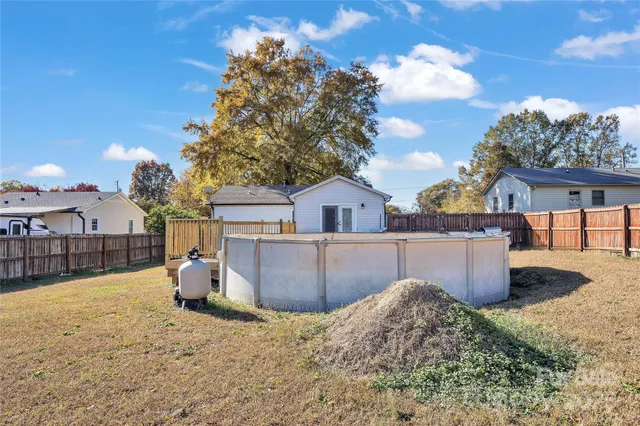 a view of a backyard with a tree