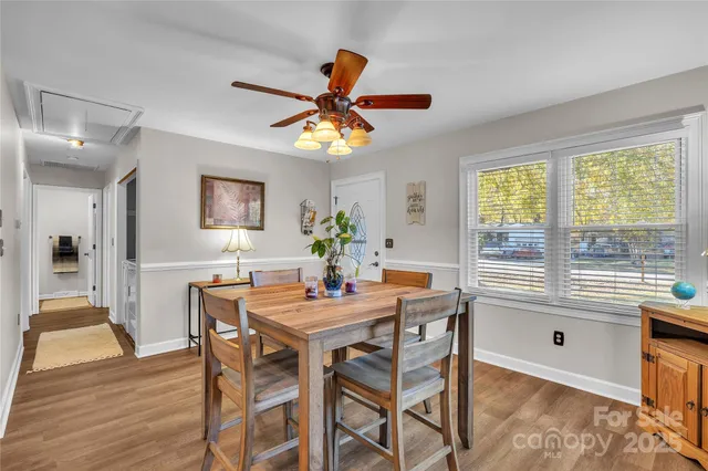 a dining room with furniture a window and a chandelier