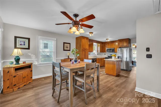 a view of a dining room with furniture and a chandelier