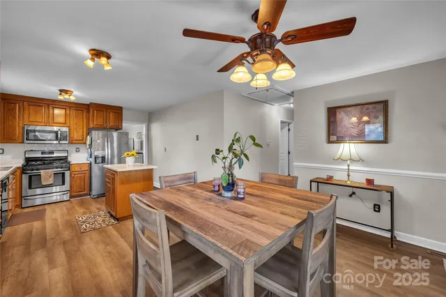 a kitchen with a table chairs and microwave