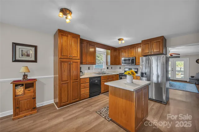 a kitchen with a sink appliances and cabinets