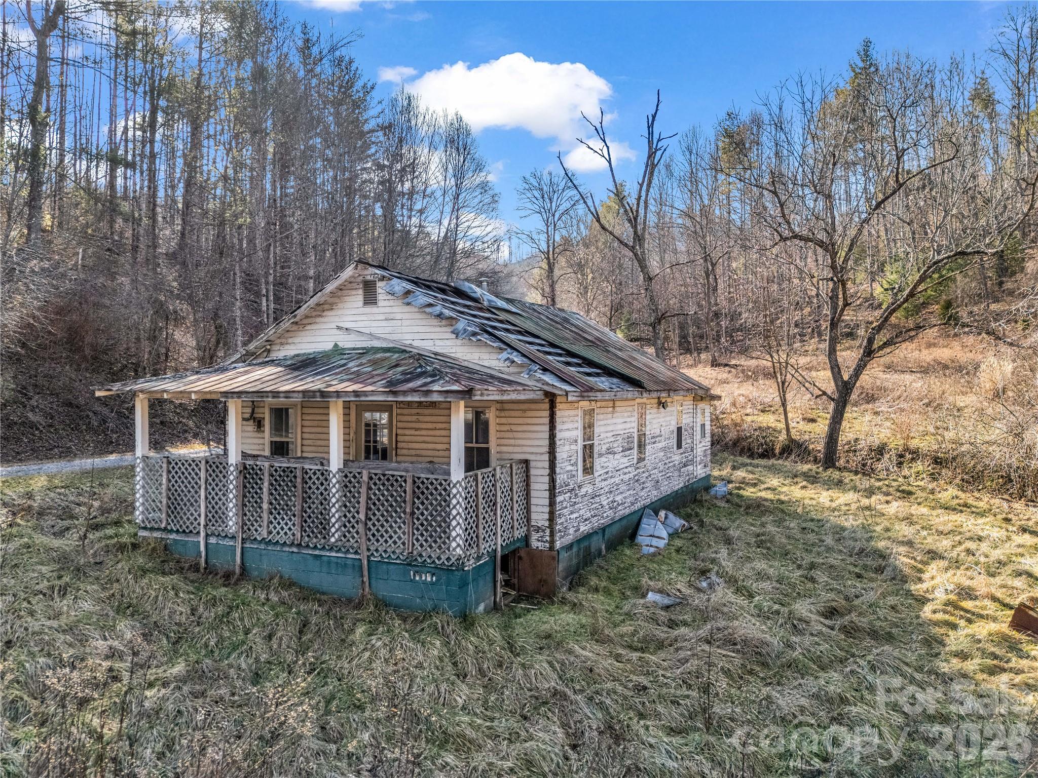 530 Mine Creek Road Bakersville, NC 28705 - Photo 7 of 18 a view of a house with a yard and wooden fence