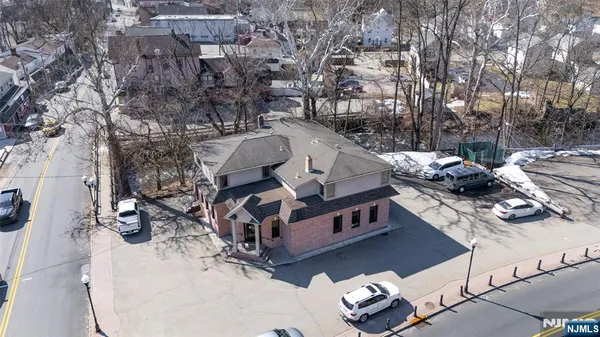 a view of roof deck with couches and wooden floor