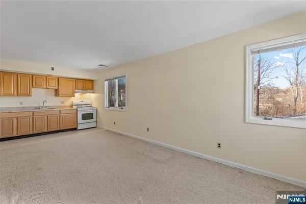 a view of a kitchen with a sink cabinets and wooden floor