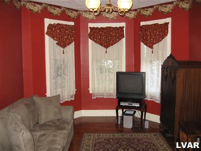 710 Spring Street Bethlehem, PA 18018 - Photo 3 of 8 a living room with furniture and a flat screen tv