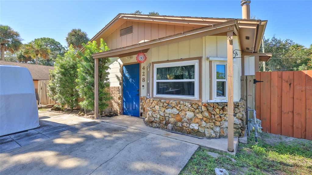 428 Perdita Avenue Edgewater, FL 32132 - Photo 1 of 28 a view of a house with wooden fence and large windows