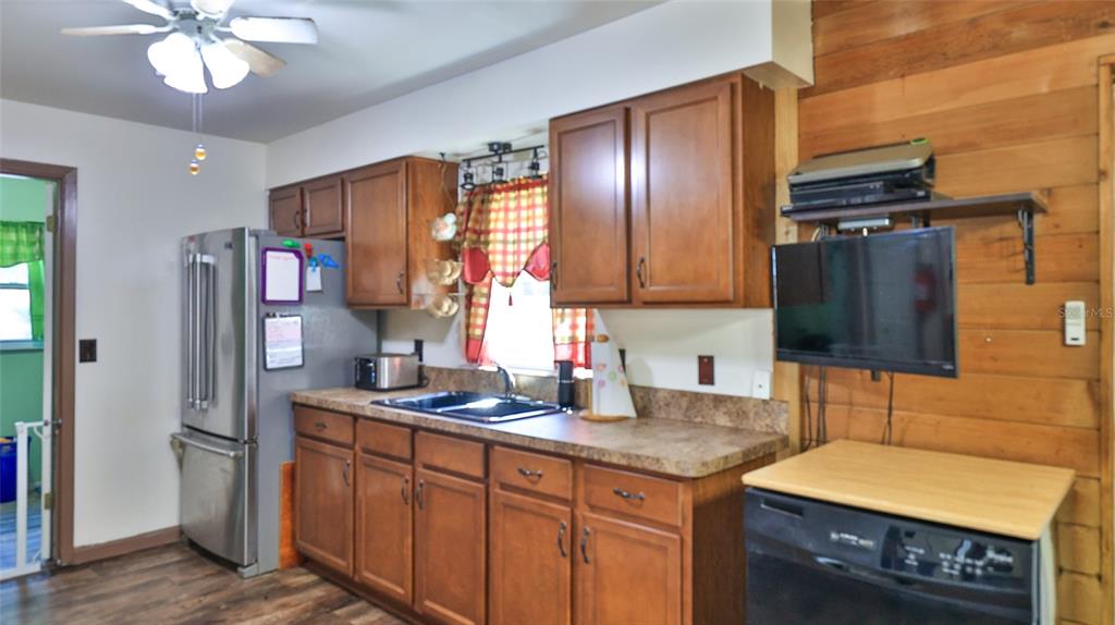 428 Perdita Avenue Edgewater, FL 32132 - Photo 11 of 28 a kitchen with stainless steel appliances granite countertop a sink refrigerator and microwave