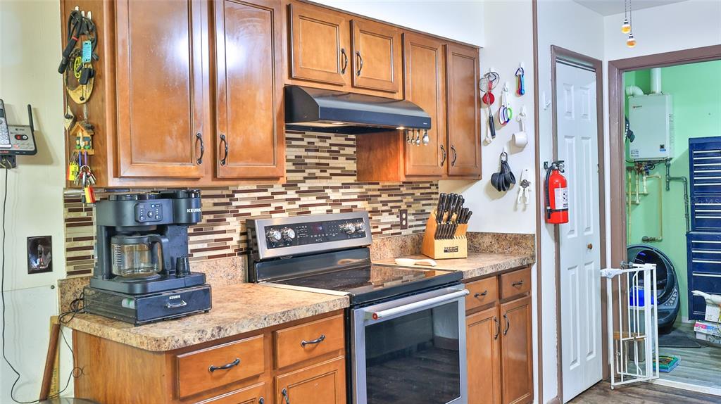 428 Perdita Avenue Edgewater, FL 32132 - Photo 12 of 28 a kitchen with stainless steel appliances granite countertop a sink stove and cabinets