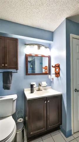 a bathroom with a sink toilet and mirror