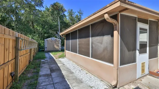 a view of a house with a yard and wooden fence