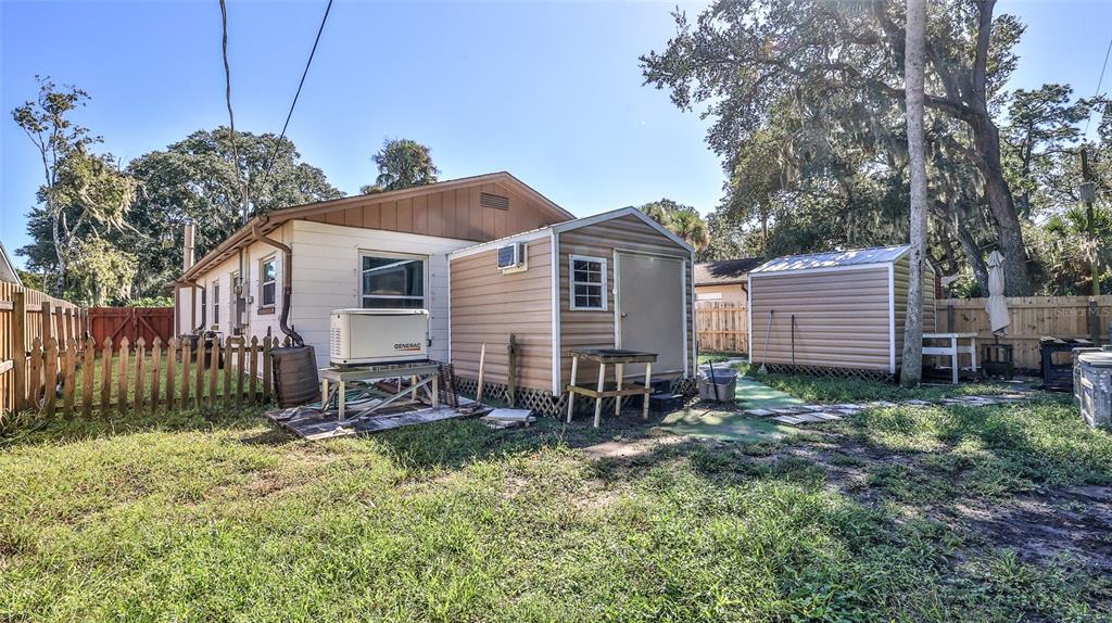 428 Perdita Avenue Edgewater, FL 32132 - Photo 25 of 28 a view of a house with a yard and wooden fence