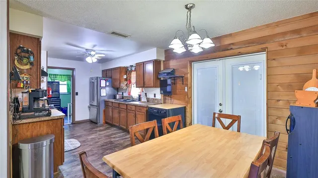 a large kitchen with a table and chairs