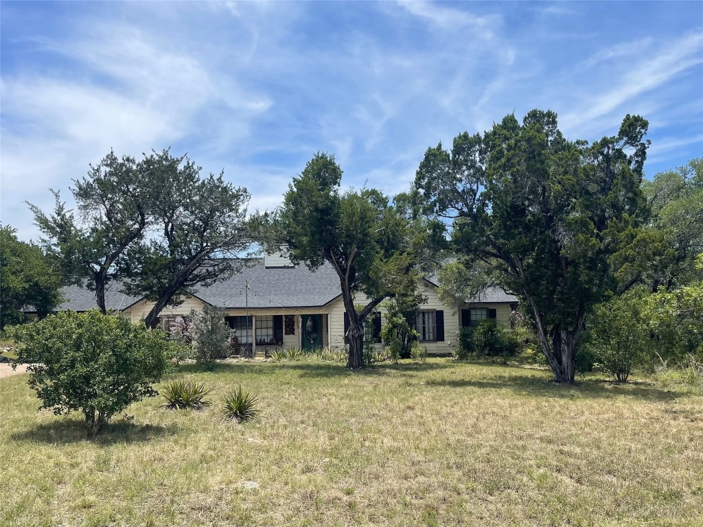13603 Overland Pass Bee Cave, TX 78738 - Photo 1 of 30 a front view of a house with a yard