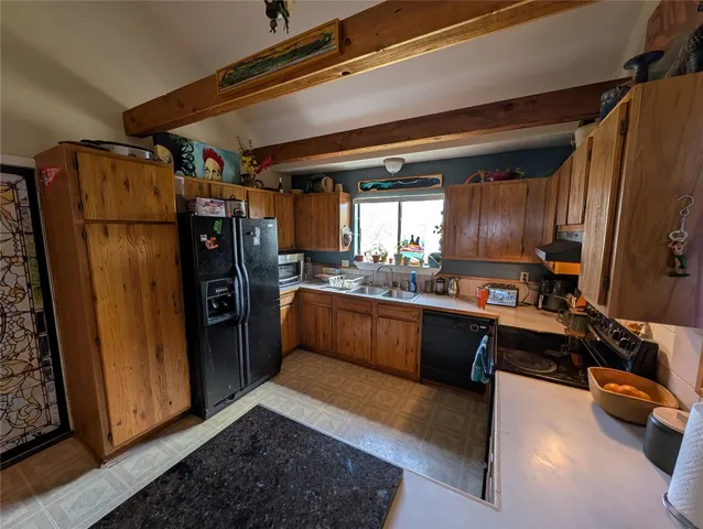 a kitchen with refrigerator and window