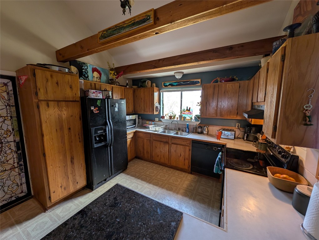 13603 Overland Pass Bee Cave, TX 78738 - Photo 11 of 30 a kitchen with refrigerator and window