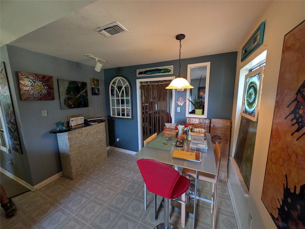 13603 Overland Pass Bee Cave, TX 78738 - Photo 12 of 30 a view of a dining room with furniture window and wooden floor