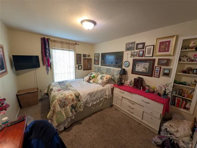 a bedroom with a bed and dresser