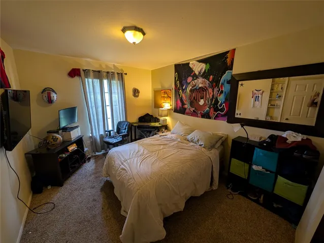 a bedroom with two beds and painting on the wall