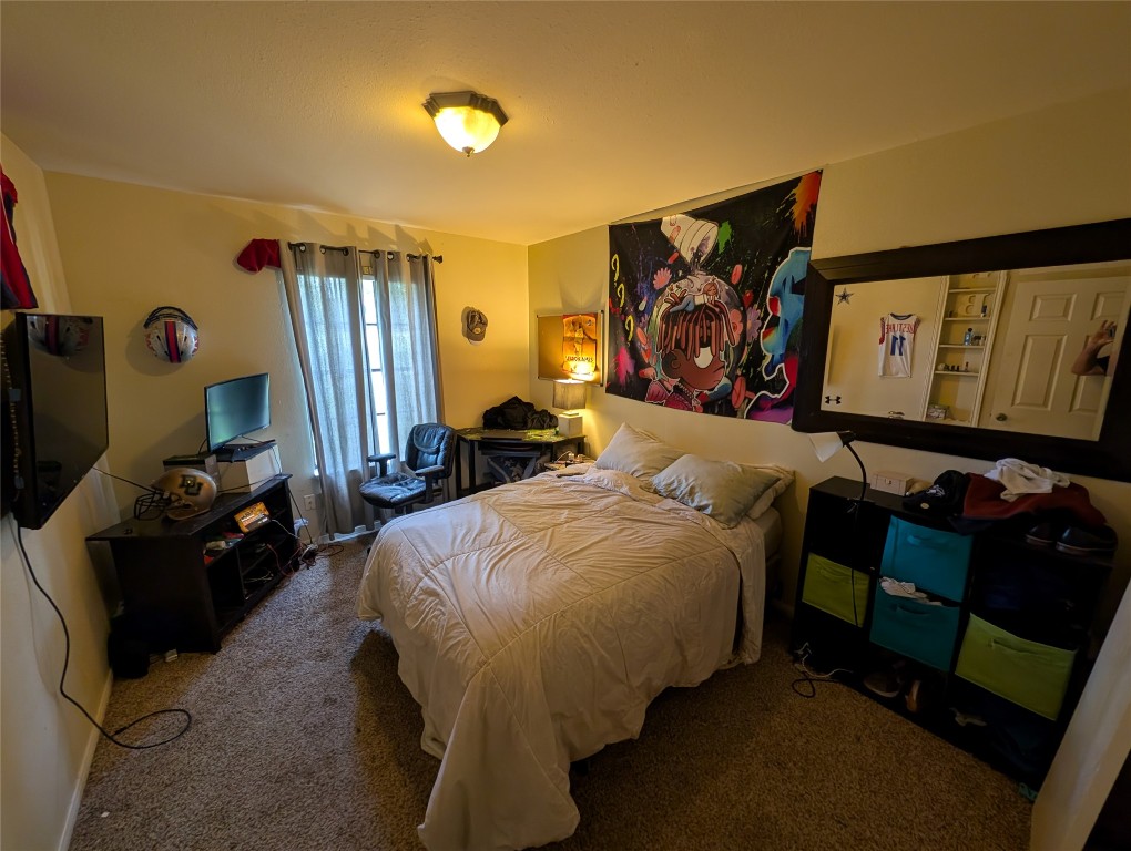 13603 Overland Pass Bee Cave, TX 78738 - Photo 17 of 30 a bedroom with a bed and dresser