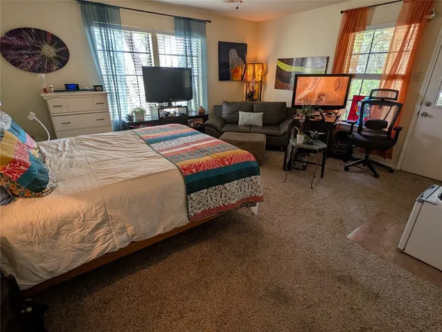 a bedroom with two beds and a window