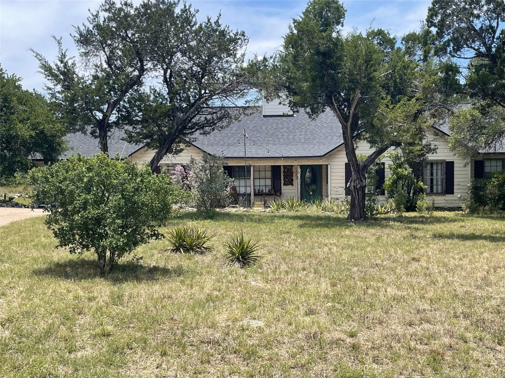13603 Overland Pass Bee Cave, TX 78738 - Photo 2 of 30 a front view of a house with a garden