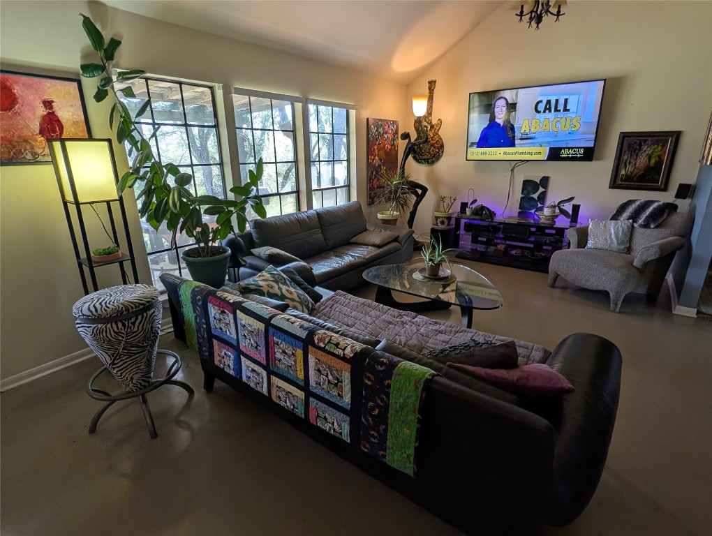 13603 Overland Pass Bee Cave, TX 78738 - Photo 7 of 30 a living room with furniture a flat screen tv and a large window