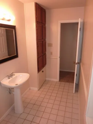 a bathroom with a sink a toilet and a mirror