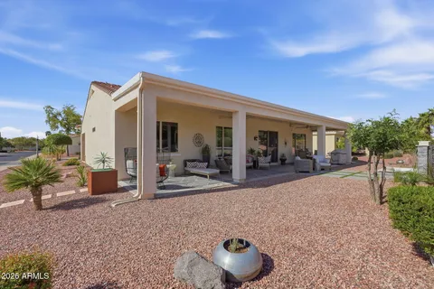 a view of a house with backyard porch and sitting area