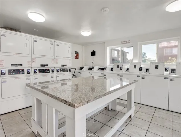a kitchen with stainless steel appliances granite countertop a sink window and cabinets