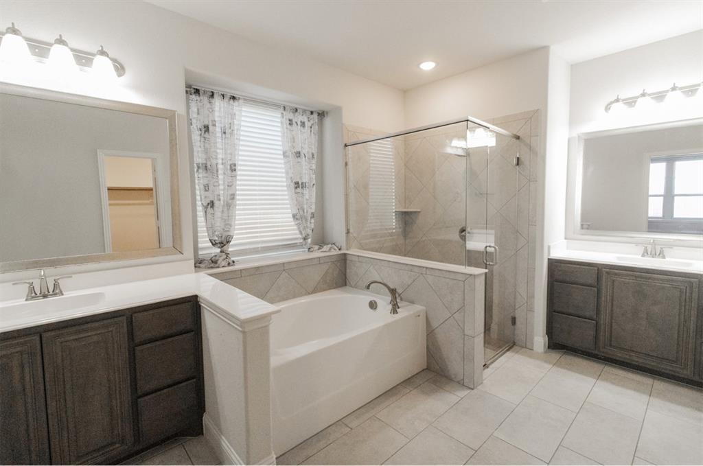 4003 Three Forks Road Kaufman, TX 75142 - Photo 8 of 14 a spacious bathroom with a tub sink shower and mirror