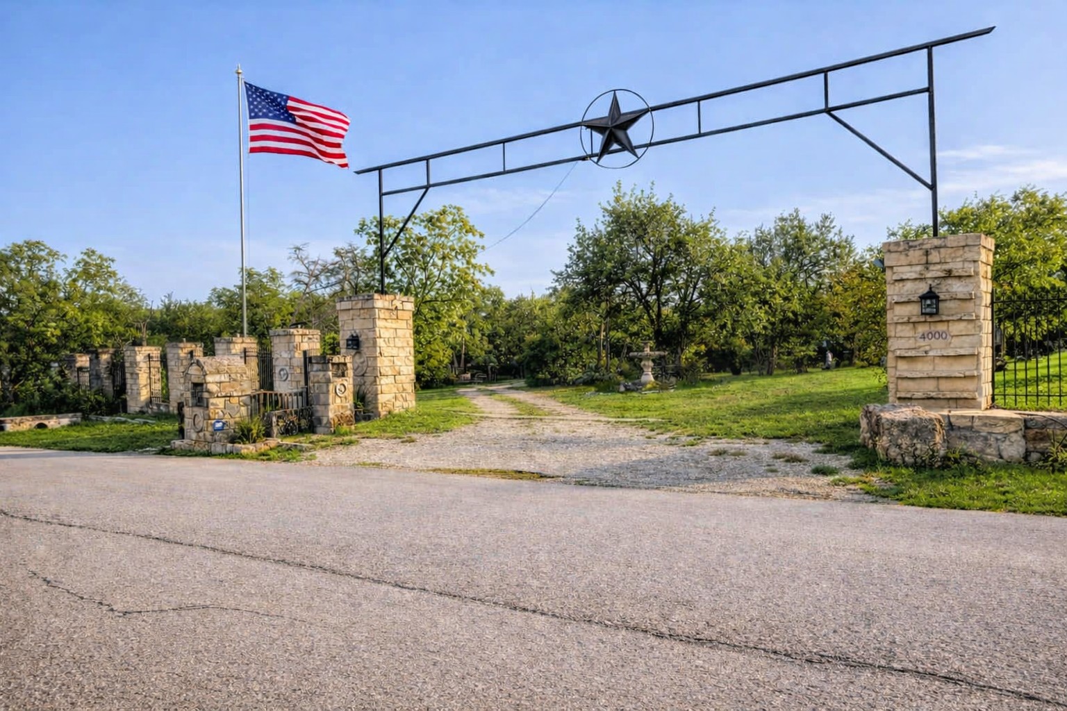 8900 Lone Tree Drive Manor, TX 78653 - Photo 1 of 1 A grand entrance with stone columns and a star emblem welcomes you to this expansive property.