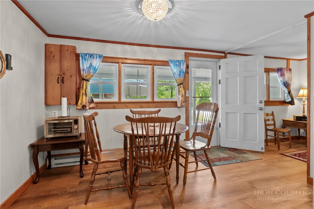 154 Folger Road Sparta, NC 28675 - Photo 14 of 37 a view of a dining room with furniture window and wooden floor
