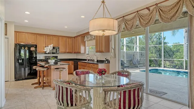 a kitchen with stainless steel appliances granite countertop a sink a stove and refrigerator