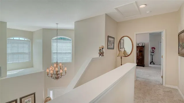 a bedroom with bed and a chandelier