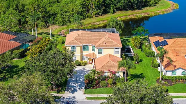 an aerial view of house with yard swimming pool and outdoor seating