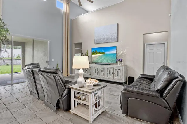 a living room with furniture a rug and a painting on the wall