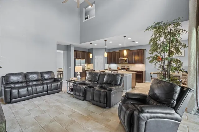a living room with furniture and a potted plant