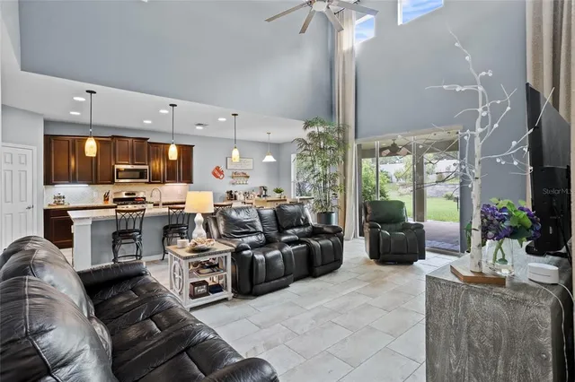 a kitchen with granite countertop a table chairs stainless steel appliances and cabinets
