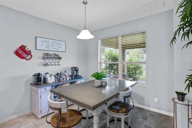 a bedroom with a bed chairs and a chandelier