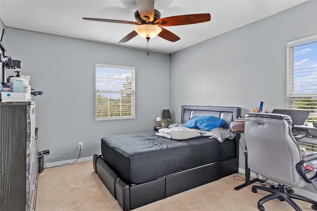 an aerial view of residential houses with outdoor space and parking