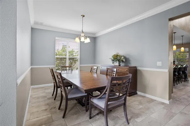 a view of a dining room with a table and chairs