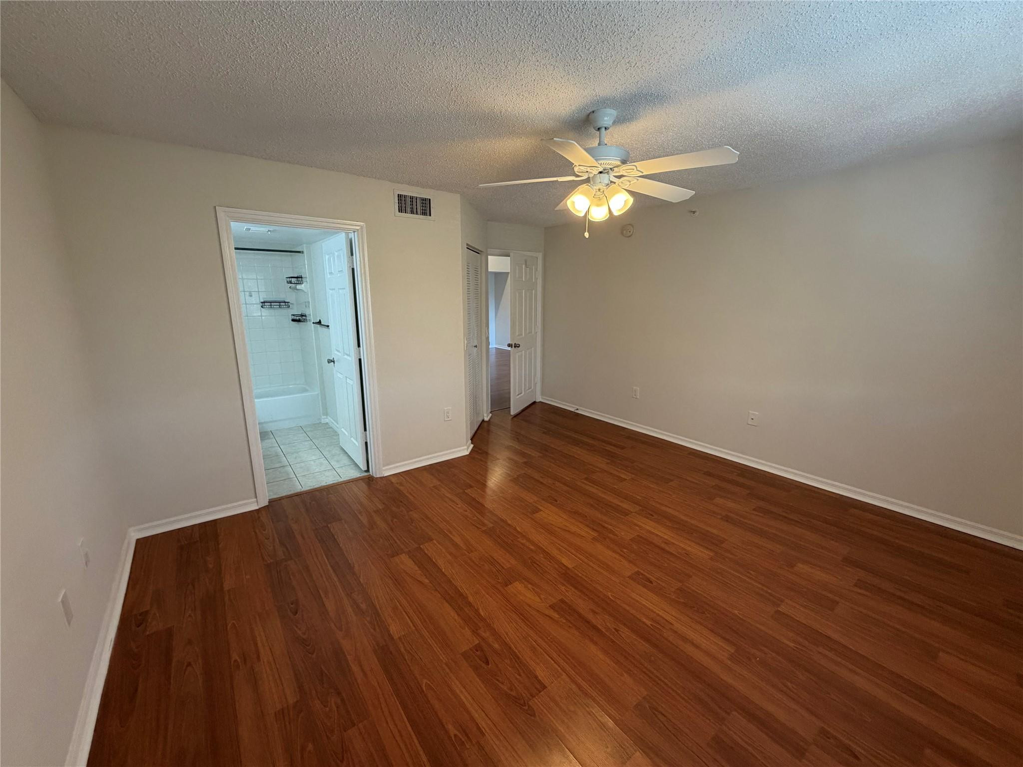 5005 Wiles Road, Unit 307 Pompano Beach, FL 33073 - Photo 12 of 28 a view of empty room with wooden floor