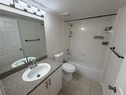 a bathroom with a sink toilet a mirror and shower