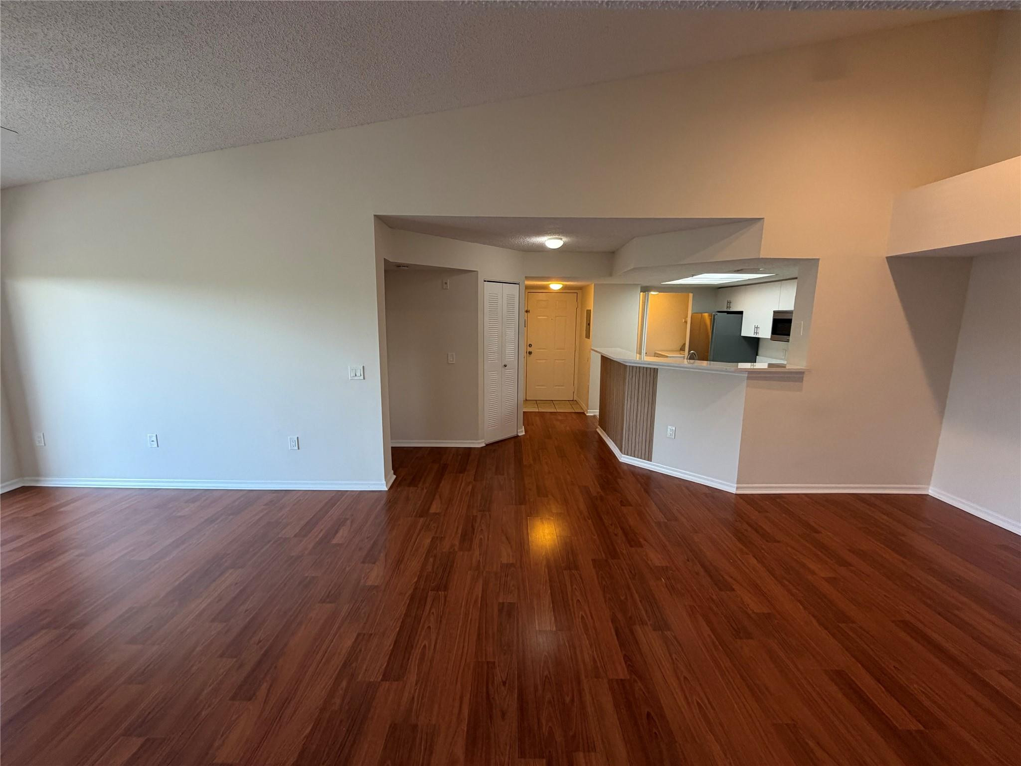 5005 Wiles Road, Unit 307 Pompano Beach, FL 33073 - Photo 18 of 28 a view of a kitchen with wooden floor and a sink