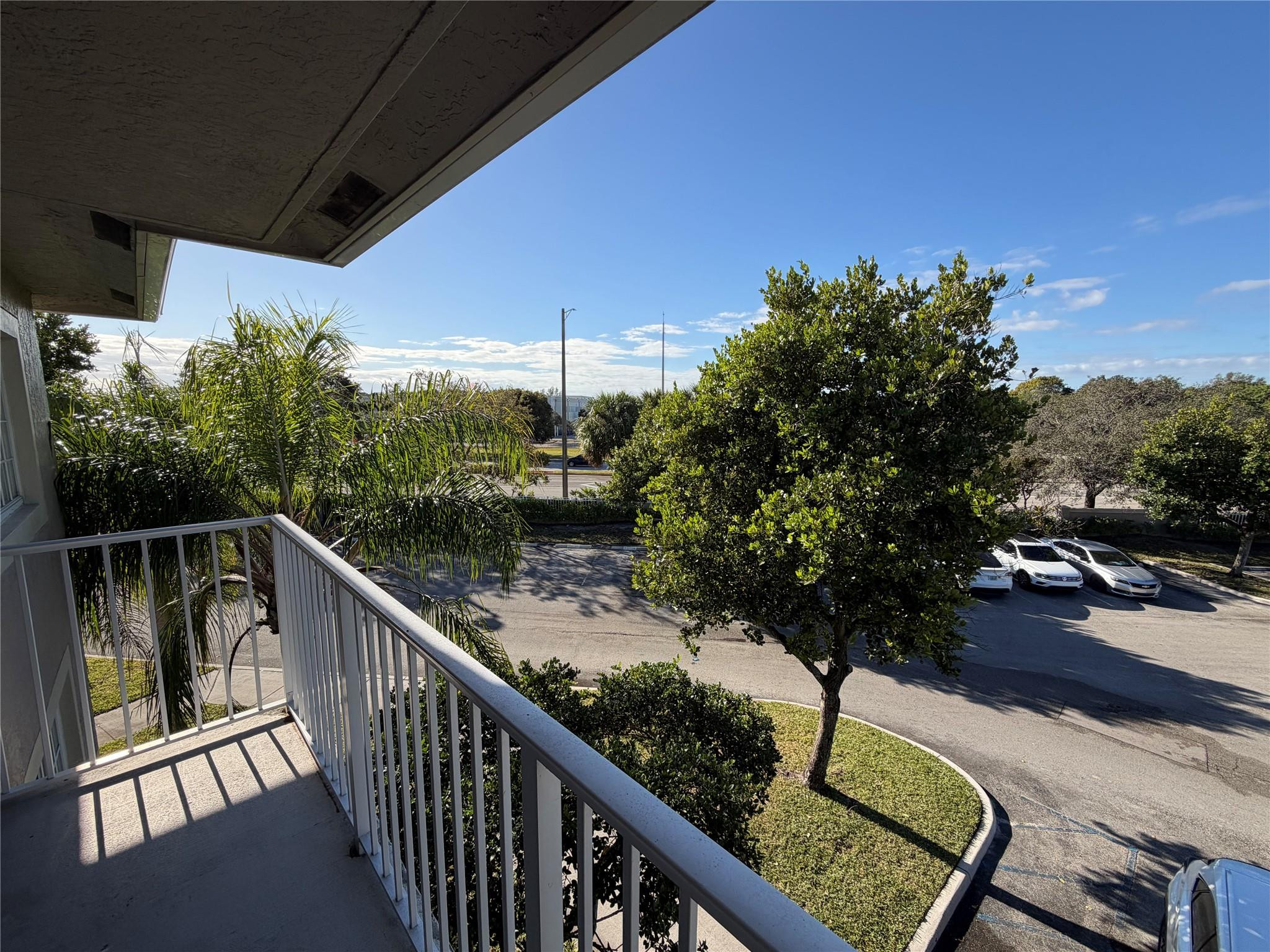 5005 Wiles Road, Unit 307 Pompano Beach, FL 33073 - Photo 21 of 28 a view of a balcony with yard