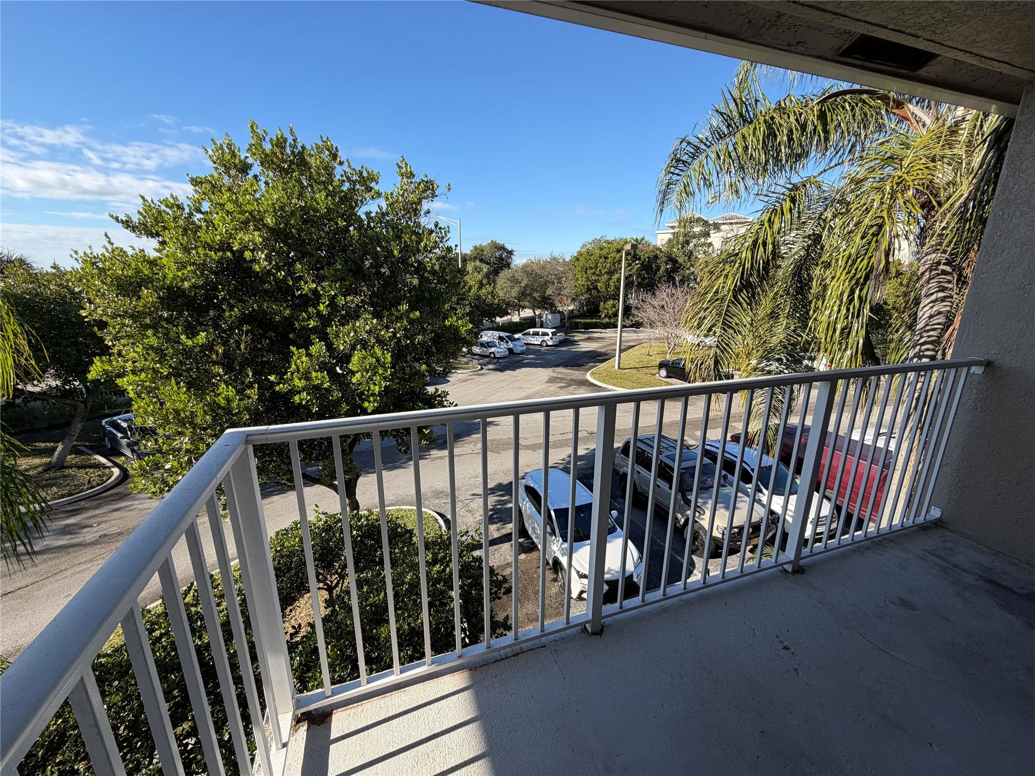 5005 Wiles Road, Unit 307 Pompano Beach, FL 33073 - Photo 22 of 28 a view of balcony with wooden floor and fence