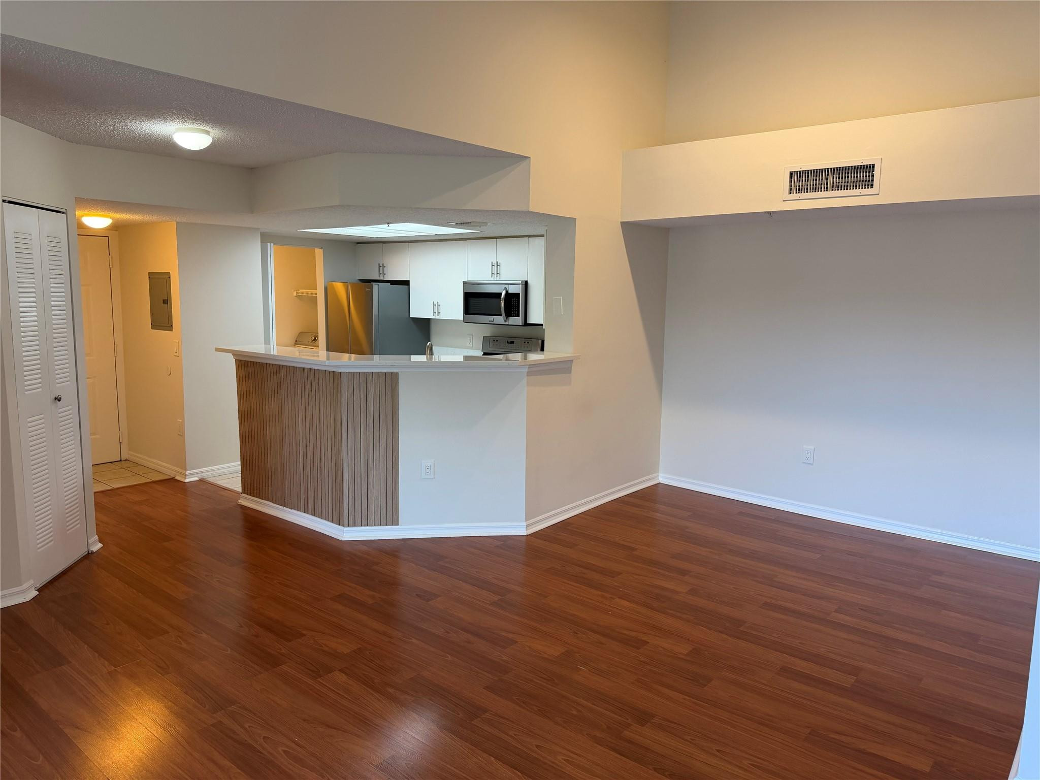 5005 Wiles Road, Unit 307 Pompano Beach, FL 33073 - Photo 4 of 28 a view of kitchen with wooden floor