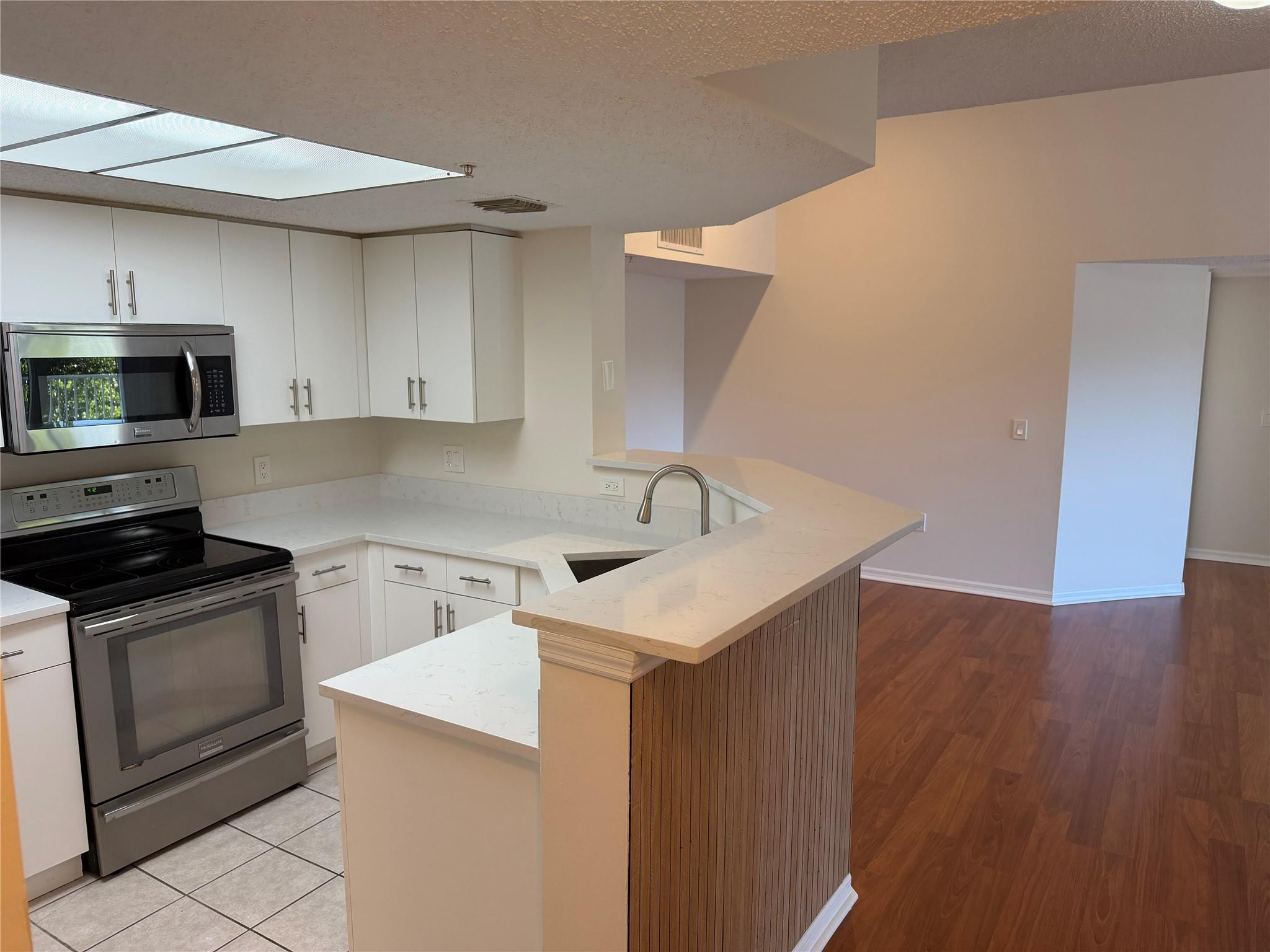 5005 Wiles Road, Unit 307 Pompano Beach, FL 33073 - Photo 8 of 28 a kitchen with a sink and a stove top oven